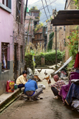 <b>NPL1130</b><br>Nepal; Kathmandu Valley; Panauti; Village; Street; People; Grandfather; Family; Rest; Relax; Talk; Chicken; Building; House
