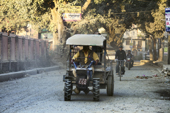 <b>NPL1149</b><br>Nepal; Kathmandu; Street; People; Transport; Dust; Vehicle; Motorbike; Road; Tractor; Bicycle